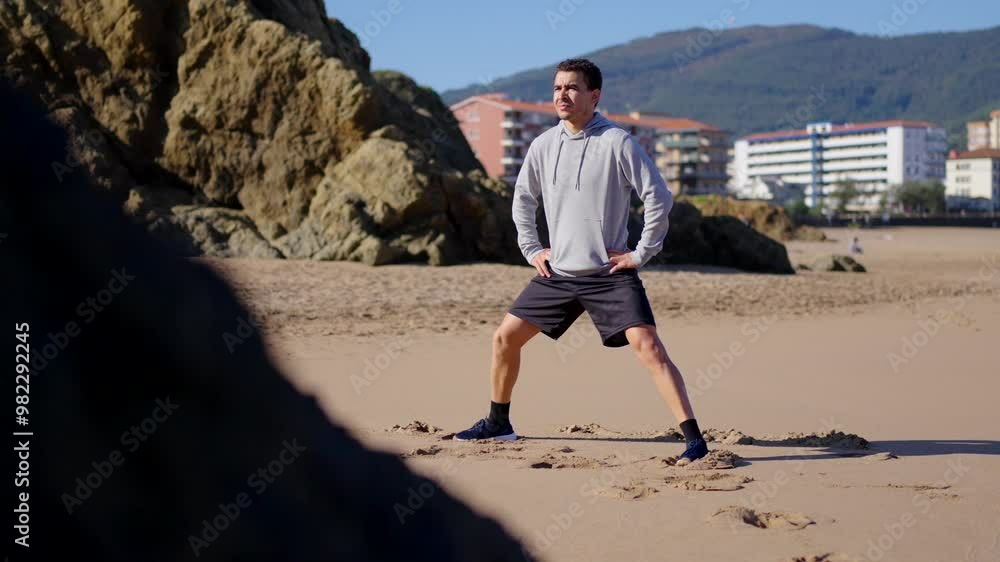 Moroccan athlete doing warm up exercise outdoors, at the beach. Moroccan athlete doing warm up exercise outdoors, at the beach.