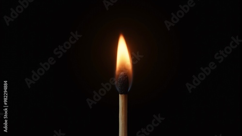 a match is burning on a black background in close-up