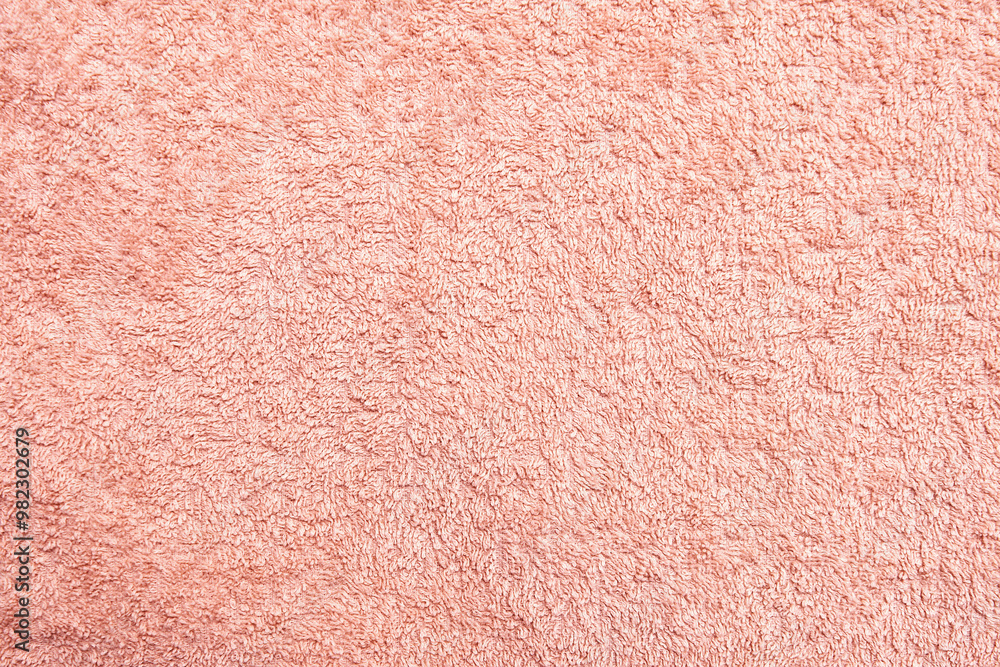 Fototapeta premium Detailed texture of the pink terrycloth towel. The soft, fluffy texture is perfect for creating a background or adding a touch of warmth to design