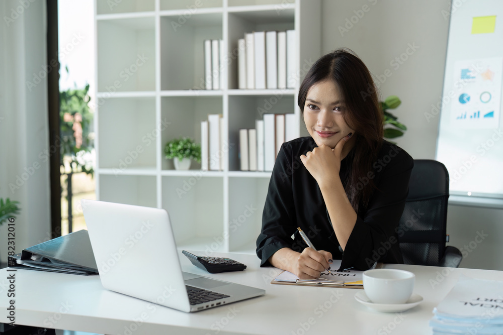 Confident Businesswoman Working at Desk with Laptop in Modern Office Environment Confident Businesswoman Working at Desk with Laptop in Modern Office Environment
