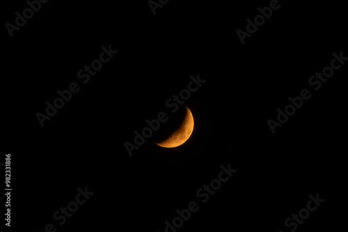 A high-resolution image of an yellow crescent moon against a dark sky. The moon is crisp and detailed, making it perfect for compositing.