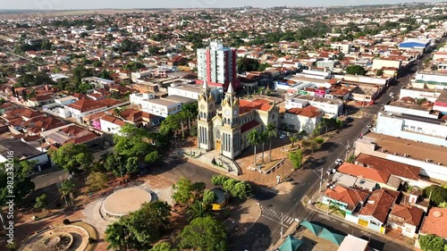 Timelapse of Igreja Nossa Senhora do Carmo and the main square in Frutal, MG, Brazil, capturing the movement of people, shadows, and city life as day transitions to night in this historic area. photo