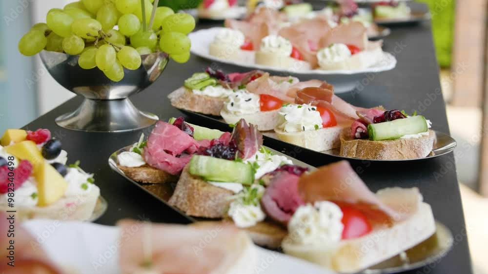Close-up of canapes with cream cheese, meat, vegetables and berries on a banquet table in a restaurant. Buffet table. Close-up of canapes with cream cheese, meat, vegetables and berries on a banquet table in a restaurant. Buffet table.