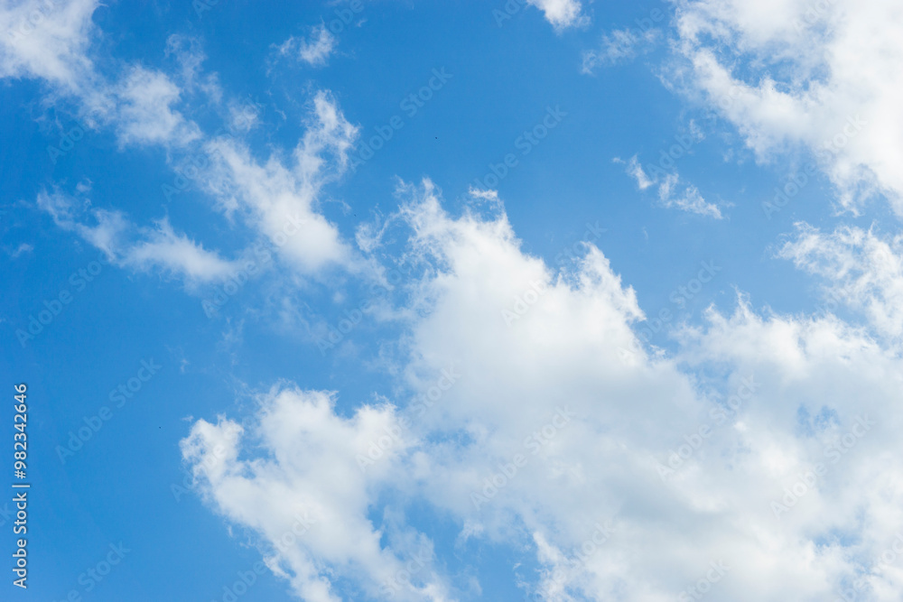 Sky is blue and clear with clouds. The sky is very bright and the sun is shining Sky is blue and clear with clouds. The sky is very bright and the sun is shining