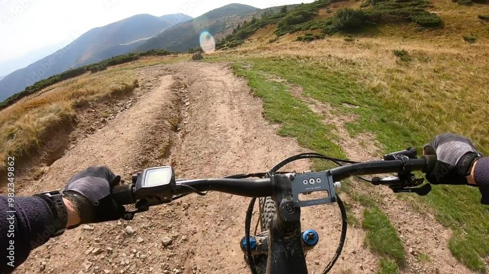 Point of view. Cyclist riding electric mountain bike in the mountains. Concept of adventure, leisure time outdoors. Point of view. Cyclist riding electric mountain bike in the mountains. Concept of adventure, leisure time outdoors.