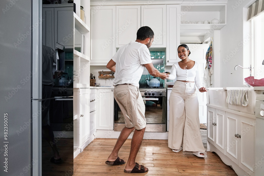Smiling couple dancing in kitchen Smiling couple dancing in kitchen