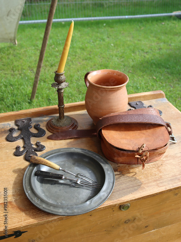 Wallpaper Mural A 17th century place setting, with a jug, a candle stick and pewter plate and a leather pouch. Torontodigital.ca