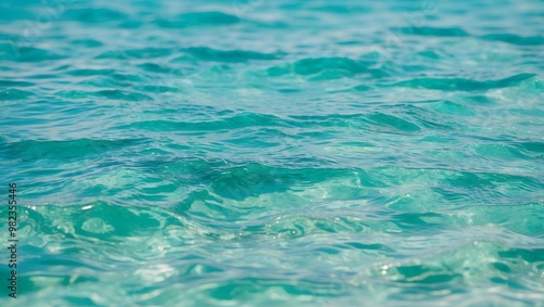 close-up view of a body of water with a calm surface. The water appears to be a deep teal color, reflecting the surroundings and creating a serene atmosphere.