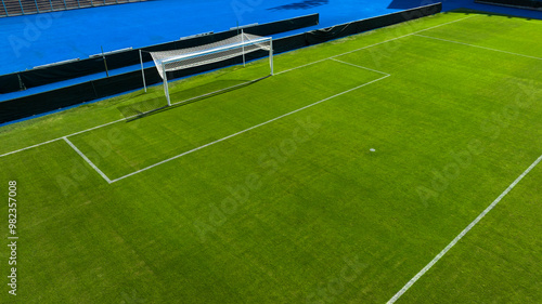 Aerial closeup of the penalty area on an empty grass soccer field. Here a penalty is taken in a soccer game.