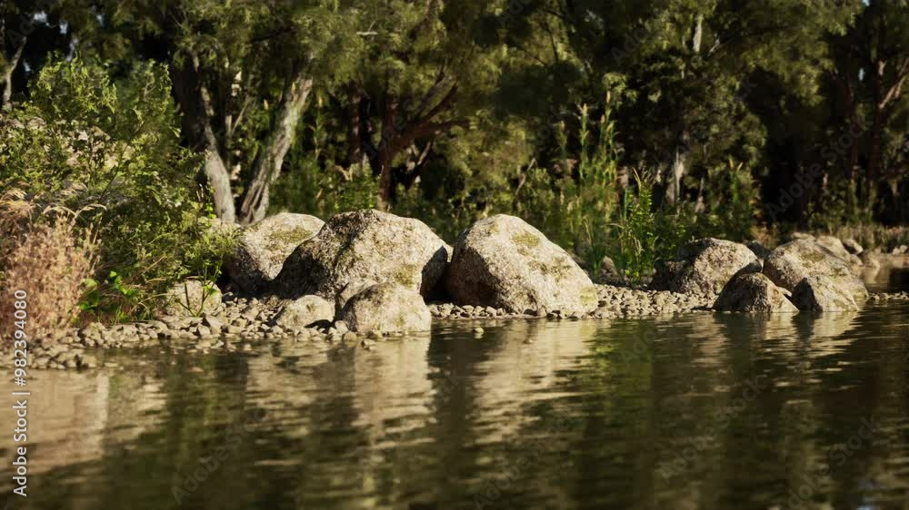 A serene riverbank reveals smooth rocks and vibrant green plants, softly reflecting on the waters surface in bright sunlight, creating a peaceful natural environment. A serene riverbank reveals smooth rocks and vibrant green plants, softly reflecting on the waters surface in bright sunlight, creating a peaceful natural environment.