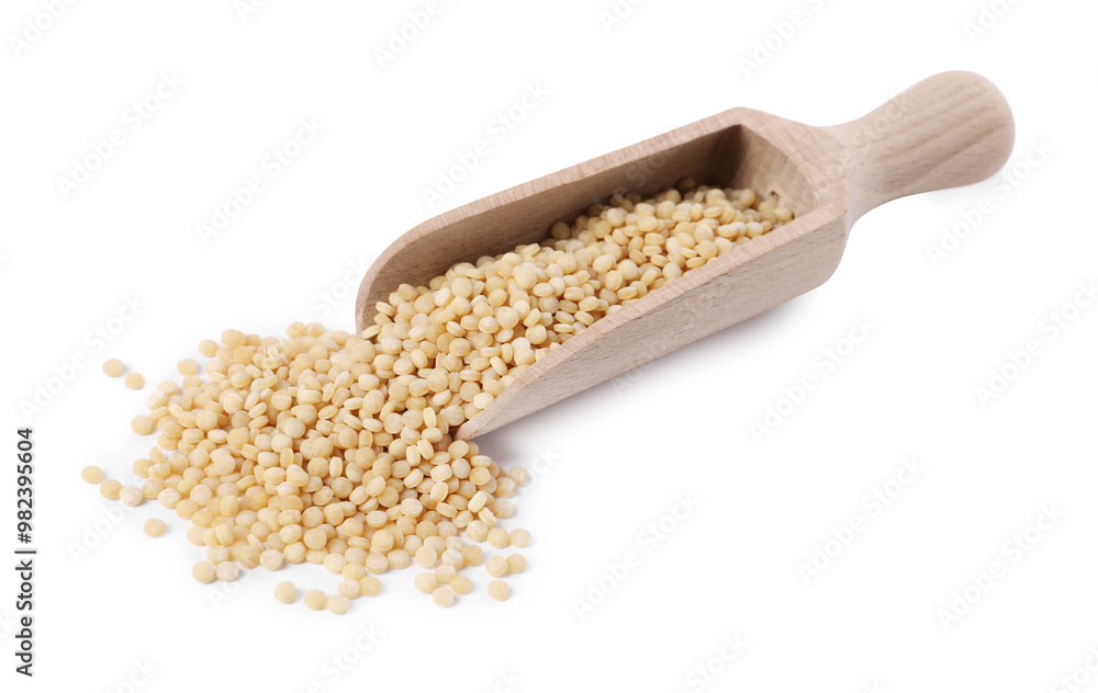 Raw couscous in wooden scoop isolated on white Raw couscous in wooden scoop isolated on white
