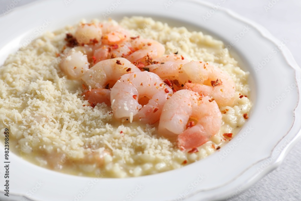Delicious risotto with shrimps and cheese on table, closeup Delicious risotto with shrimps and cheese on table, closeup