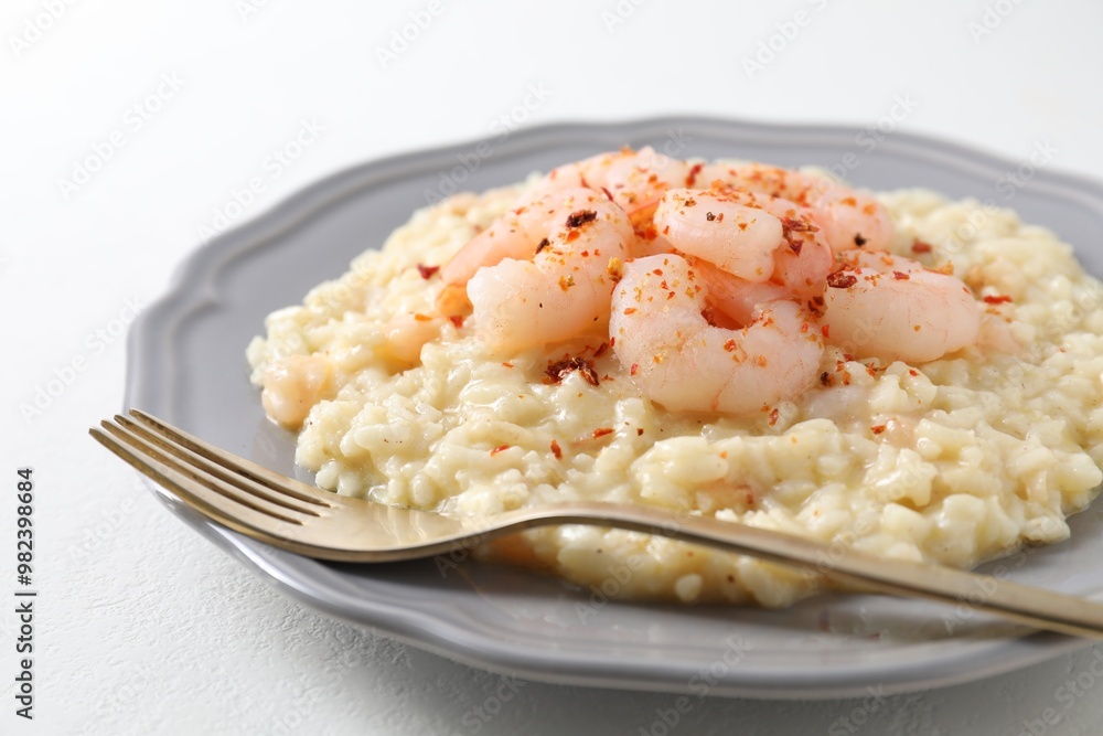 Delicious risotto with shrimps and cheese on white table, closeup Delicious risotto with shrimps and cheese on white table, closeup