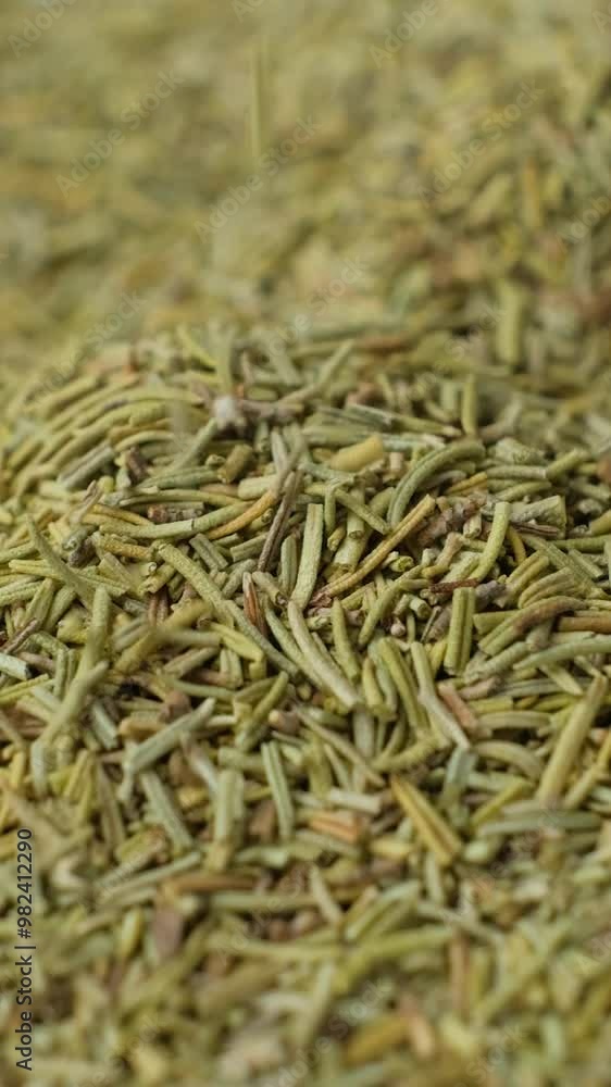 Spice rosemary pours macro vertical slow motion Spice rosemary pours macro vertical slow motion