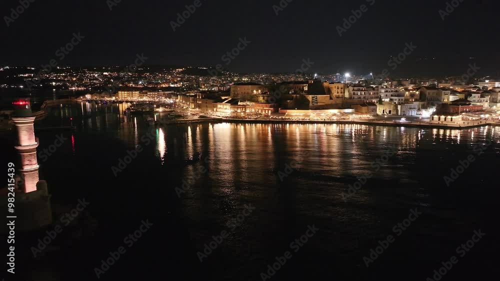 Chania town by night, Lighthouse, Drone shot, Crete, Greece, Aerial view of Chania with the amazing lighthouse, Beautiful Old city, Greece and best scenic places - panorama of picturesque old town Chania town by night, Lighthouse, Drone shot, Crete, Greece, Aerial view of Chania with the amazing lighthouse, Beautiful Old city, Greece and best scenic places - panorama of picturesque old town