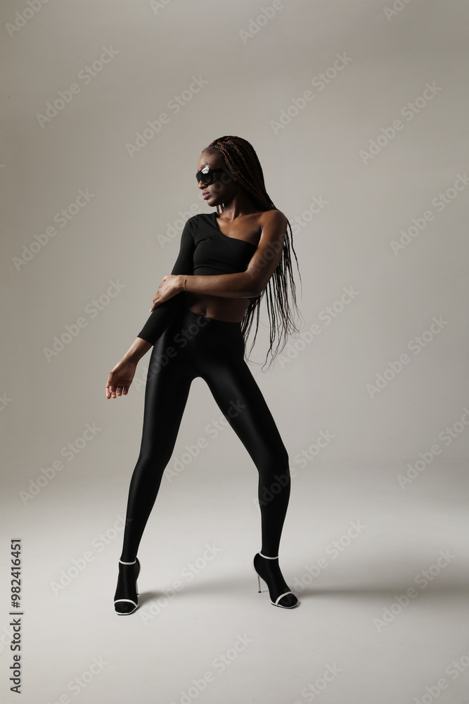 Young gorgeous woman with long braids dancing indoor. Vertical. Young gorgeous woman with long braids dancing indoor. Vertical.