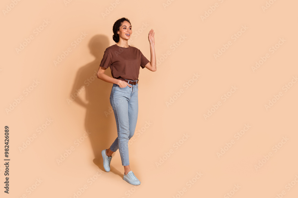 Photo of pretty nice glad adorable woman wear brown trendy clothes look empty space isolated on beige color background Photo of pretty nice glad adorable woman wear brown trendy clothes look empty space isolated on beige color background