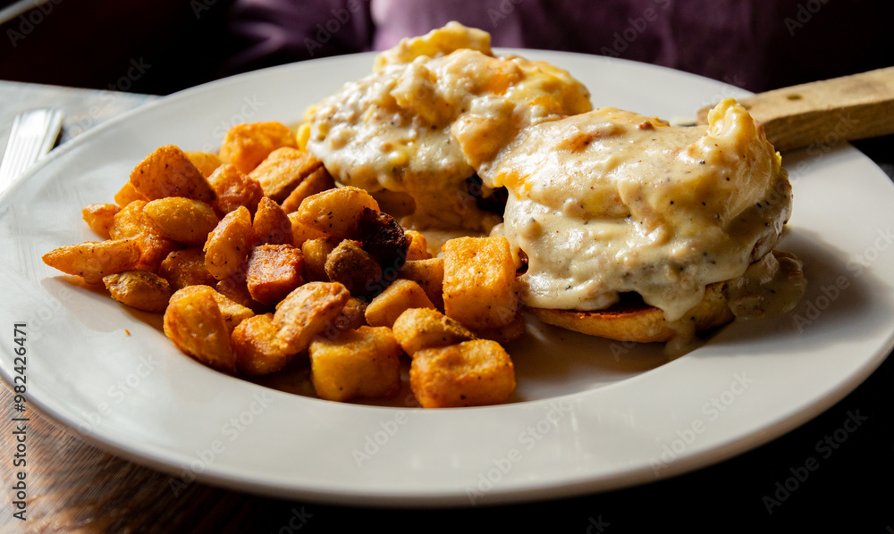grilled homemade biscuit topped with two sausage patties, two scrambled eggs bacon cheddar cheese and sausage gravy served with home fries grilled homemade biscuit topped with two sausage patties, two scrambled eggs bacon cheddar cheese and sausage gravy served with home fries