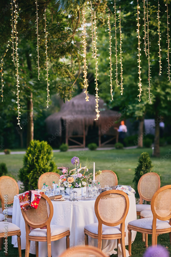 Outdoor Wedding Reception with Brown Chairs and Decorated Tables on a Green Lawn in a Scenic Nature Setting