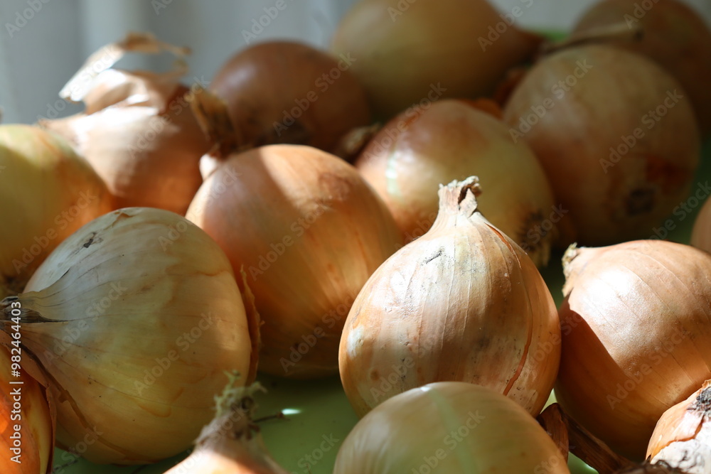 A stack of onions sitting on a table A stack of onions sitting on a table