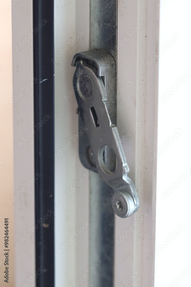 A detailed shot of a metal window latch, perfect for use in architectural or product photography A detailed shot of a metal window latch, perfect for use in architectural or product photography