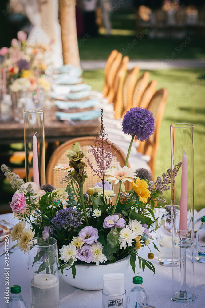 Outdoor Wedding Reception with Brown Chairs and Decorated Tables on a Green Lawn in a Scenic Nature Setting