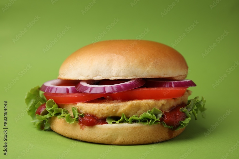 Delicious vegan burger with chickpea cutlet on green background Delicious vegan burger with chickpea cutlet on green background