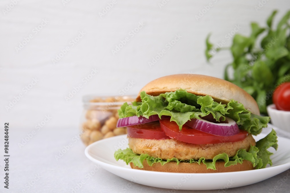 Delicious vegetarian burger with chickpea cutlet on light table, closeup. Space for text Delicious vegetarian burger with chickpea cutlet on light table, closeup. Space for text