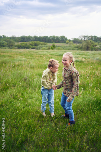 sisters hug and protect each other from the wind in the field