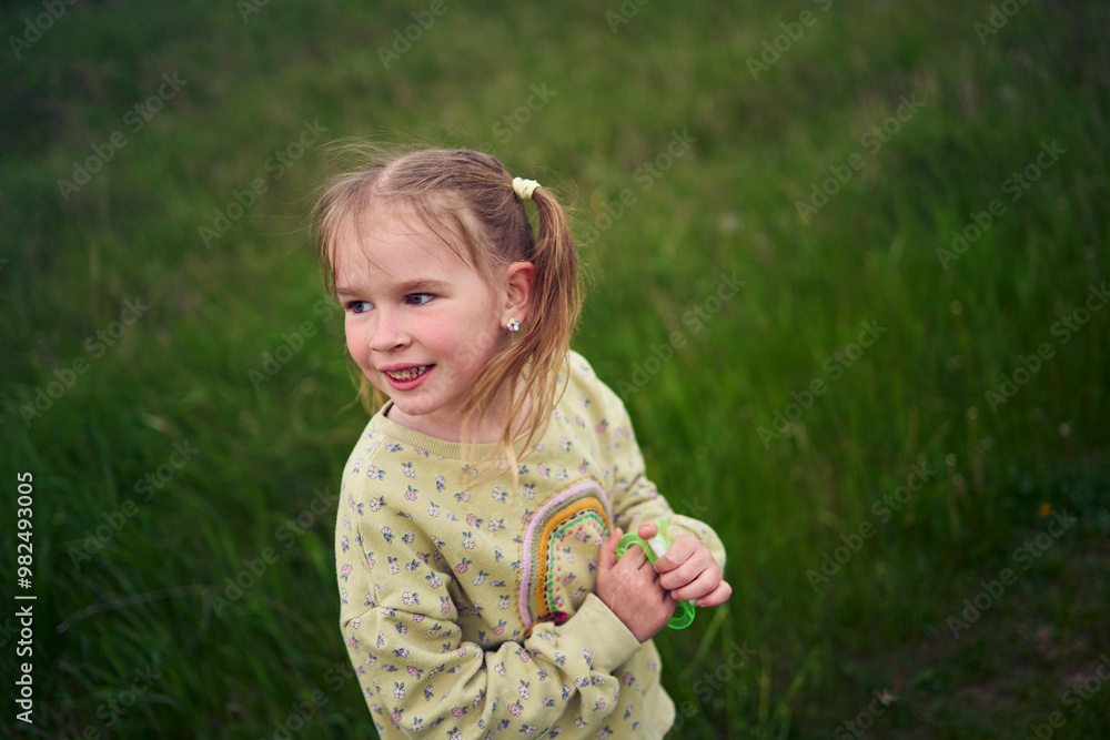 a portrait of a little blond girl in a field a portrait of a little blond girl in a field