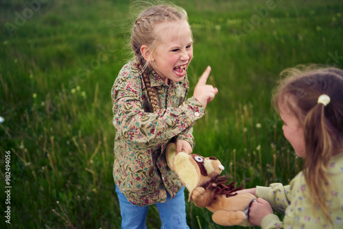 sisters fight over a toy bunny