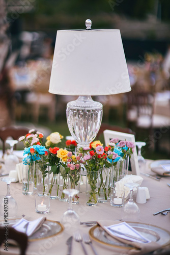 Outdoor Wedding Reception with Brown Chairs and Decorated Tables on a Green Lawn in a Scenic Nature Setting