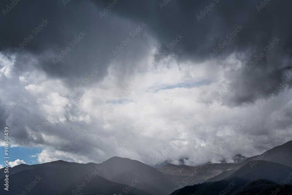 Thunderclouds over a frosty bay with mountains, dramatic sky with cumulus clouds, nature and meteorology background Thunderclouds over a frosty bay with mountains, dramatic sky with cumulus clouds, nature and meteorology background