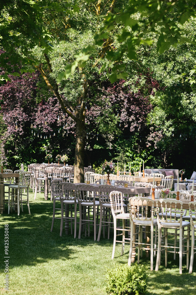 Charming Outdoor Garden Event with Wooden Tables, Soft Floral Decor, and Natural Greenery Ambience