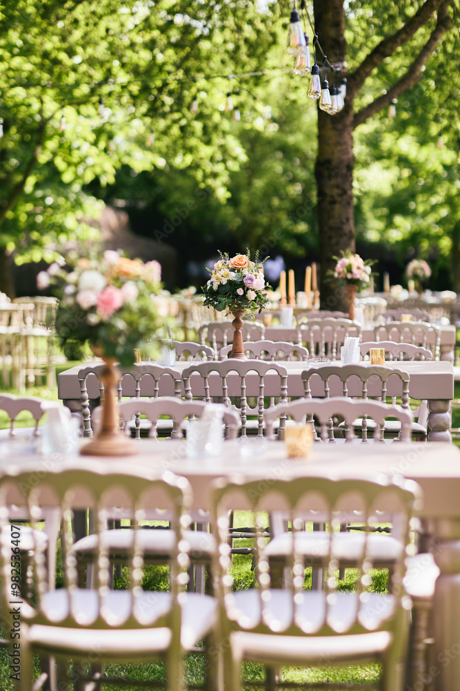 Elegant Outdoor Wedding Reception Setup with Decorated Table and Chairs