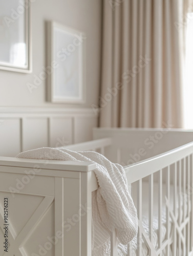 A minimalist white crib with soft blankets in a serene nursery.