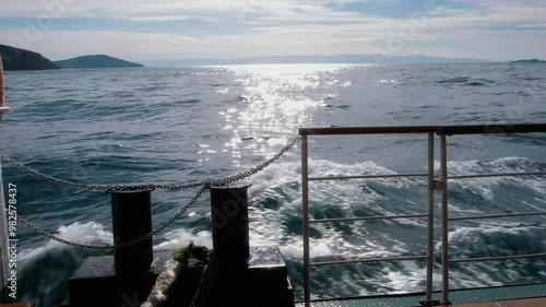 Vivid Sunlit Seascape View from the Ferry Boat Stern. Sea ocean travel concept photo