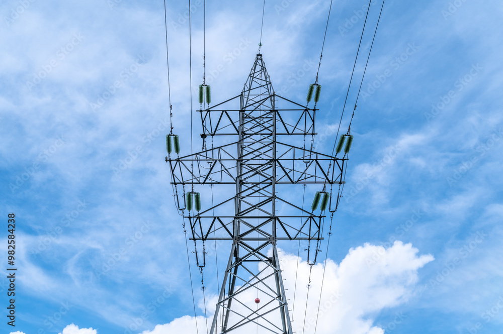 Electricity power pole with transmission lines against blue sky and clouds. Electricity power pole with transmission lines against blue sky and clouds.