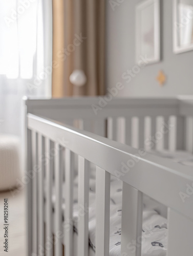 White baby crib in a bright, modern nursery room.