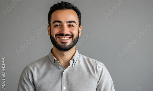 smiling gay man invite check out and see nice offer, pointing left and gazing camera