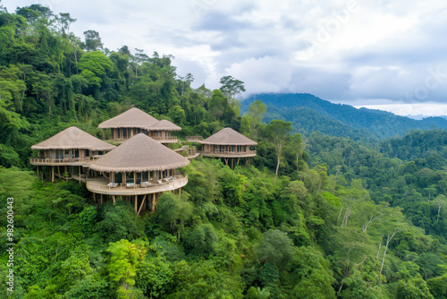 Aerial view of eco-resort built from sustainable bamboo materials, nestled in lush tropical rainforest, eco-tourism