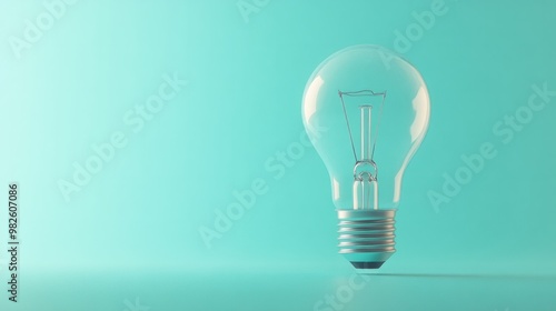 A lightbulb standing upright on a pastel aqua background.