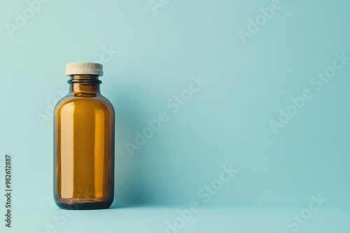 Amber glass bottle on blue background, simple design