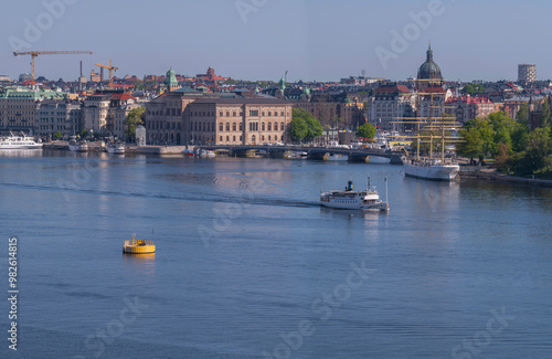 Panorama view, the bay Strömmen with moored commuting boats, steam commuter ferry leaving, a sunny summer day in Stockholm