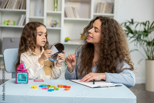 Cute long-haired girl working on her speech and looking involved and focused photo