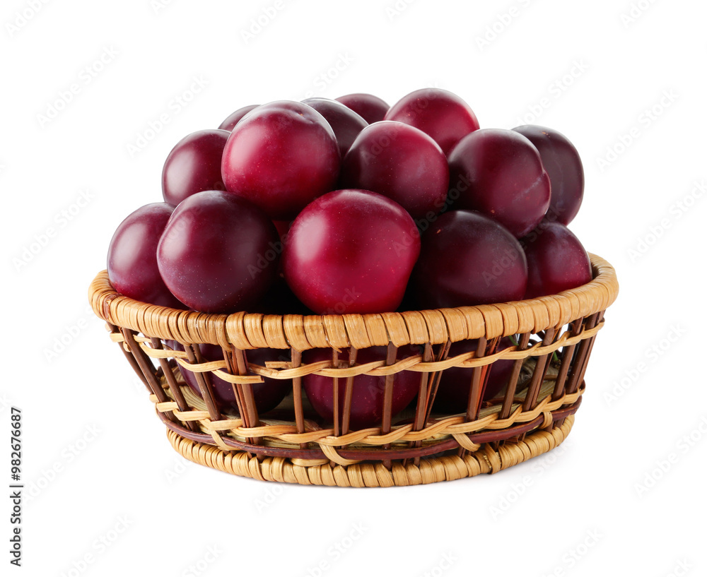Fresh ripe plums in wicker bowl isolated on white Fresh ripe plums in wicker bowl isolated on white