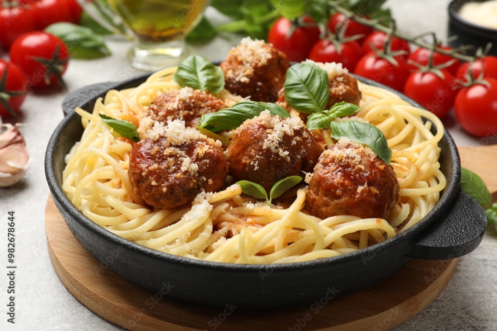 Delicious pasta with meatballs and ingredients on light grey table, closeup Delicious pasta with meatballs and ingredients on light grey table, closeup
