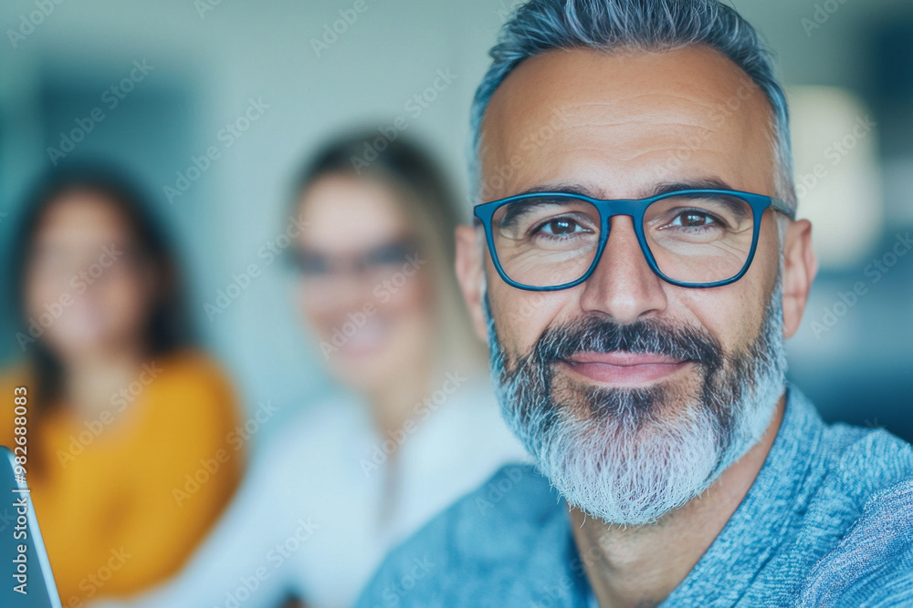 Smiling man with grey hair and beard wearing glasses. Smiling man with grey hair and beard wearing glasses.