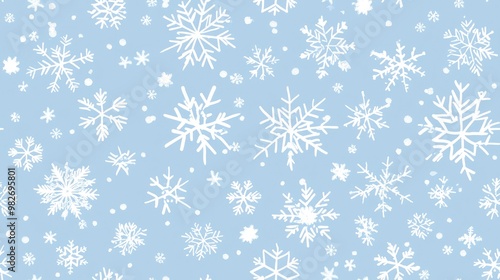 Seamless pattern featuring large and small white snowflakes on a light blue background