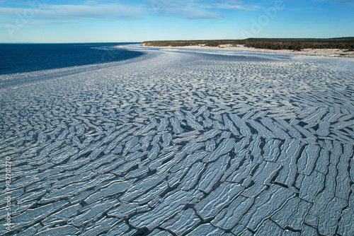 Obraz na płótnie Anticosti Stunning Coastline with Split Ice on the Seawater Surface in Fractal Patterns Seen From Above in the Northern Atlantic Ocean in Winter w salonie